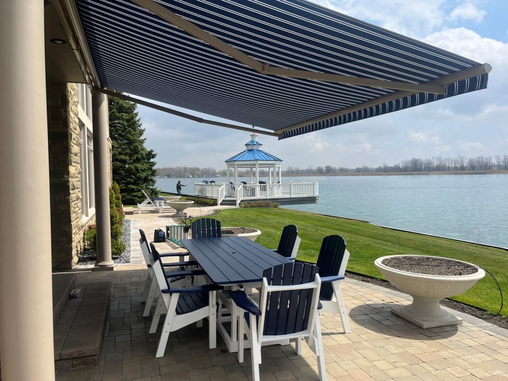 A vibrant blue retractable awning on a waterside home.